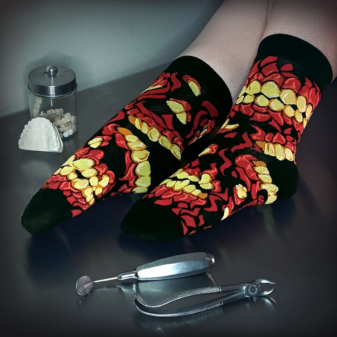 A stylistic model shot of FootClothes Chompers Crew Sock on Operating Table with Medical Tools