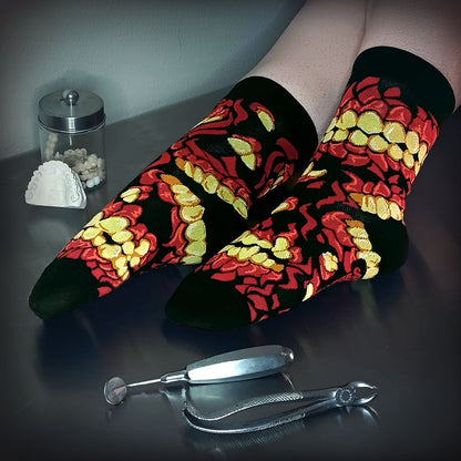 A stylistic model shot of FootClothes Chompers Crew Sock on Operating Table with Medical Tools